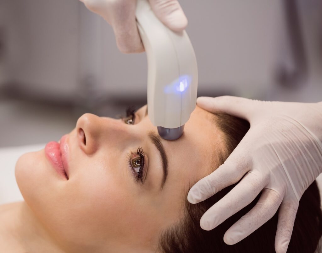 Female patient receiving cosmetic treatment at clinic